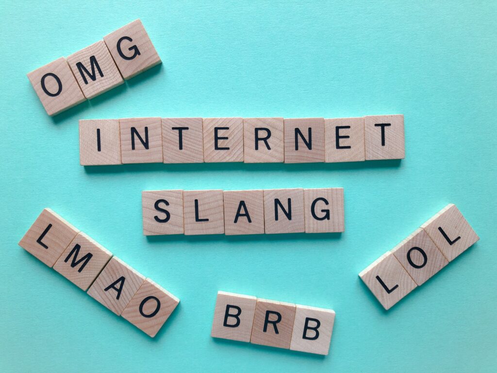 Internt Slang, word surrounded by acronyms, LOL, LMAO, OMG and BRB isolated on blue background